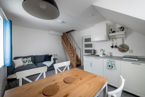 a kitchen and living room with a wooden table in a room at Marcebila Abertamy in Abertamy