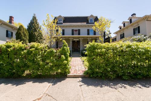 a large white house with a brick driveway at Marshall Slocum Inn in Newport