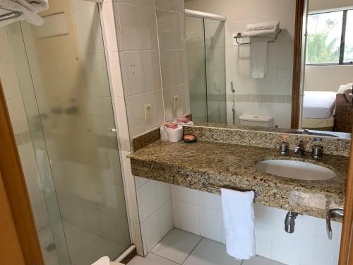 a bathroom with a sink and a shower at Tropical Executive Hotel in Manaus