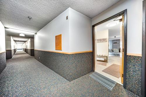 a hallway in a building with a hallway leading up to a door at Snowblaze Studio in Winter Park