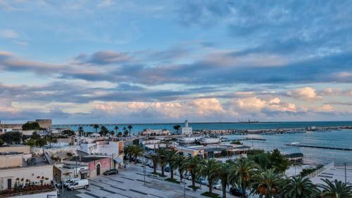 a view of a harbor with palm trees and the water at Diomede Rooms - Manfredi Homes&Villas in Manfredonia