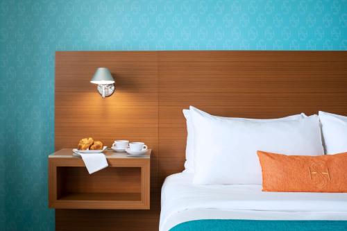 a bedroom with a bed with a wooden head board at Shore Hotel in Los Angeles