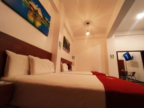 a hotel room with a large bed in a room at HOTEL SAN JUAN, Tarapoto in Tarapoto
