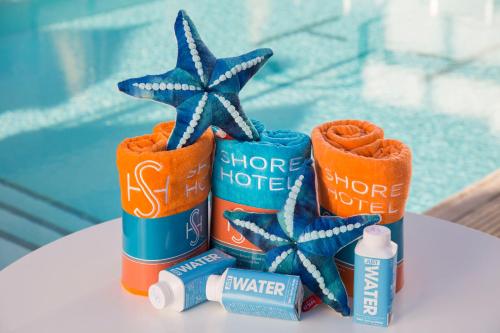 a table topped with three cans of hotter hotter water and a star at Shore Hotel in Los Angeles