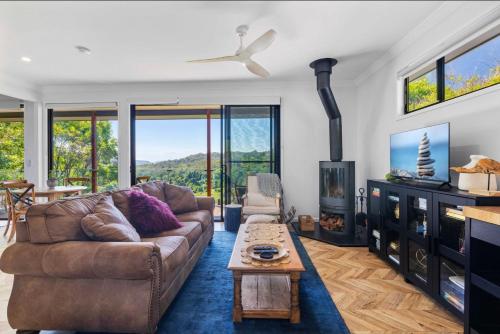 a living room with a couch and a tv at Fletchers Ridge - Guest House in Montville