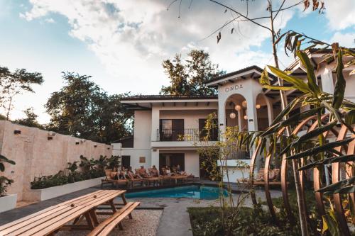 a villa with a swimming pool and a house at ONDA - Playa Grande - Adults Only in Playa Grande