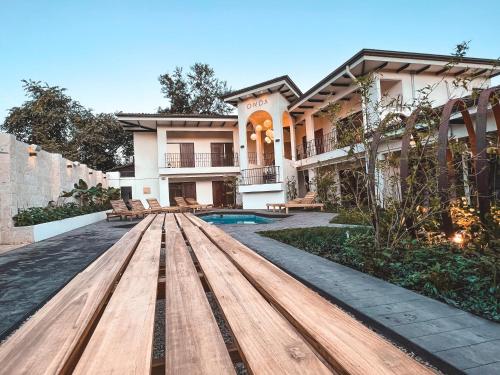a house with a wooden table in front of it at ONDA - Playa Grande - Adults Only in Playa Grande