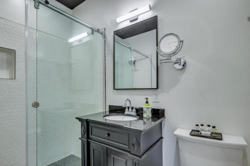 a bathroom with a sink and a shower with a mirror at Adina in Austin