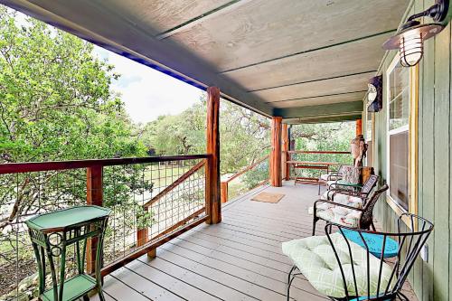 a porch with two chairs and a table at Cabin-Style Book House & Writing Barn in Austin