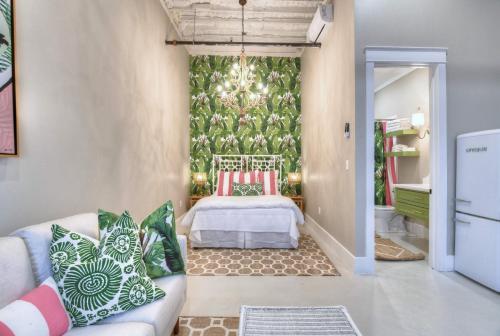 a living room with a bed and a couch at Banana Bay @emilysontheisland in Galveston