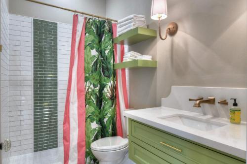 a bathroom with a shower curtain and a sink at Banana Bay @emilysontheisland in Galveston