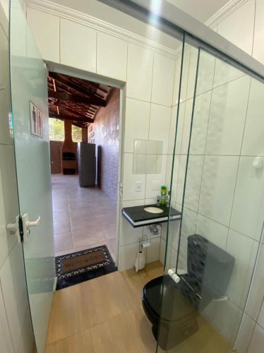 a room with a glass door leading into a room with a table at RANCHO KWILL in Serra Negra