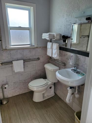 a bathroom with a toilet and a sink at Budget Inn - Saint Augustine in Saint Augustine