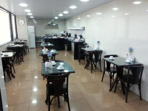 a restaurant with tables, chairs, and tables in it at Hotel Veraneio in Recife