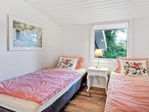 a bedroom with two beds and a window at 6 person holiday home in Vinderup-By Traum in Vinderup