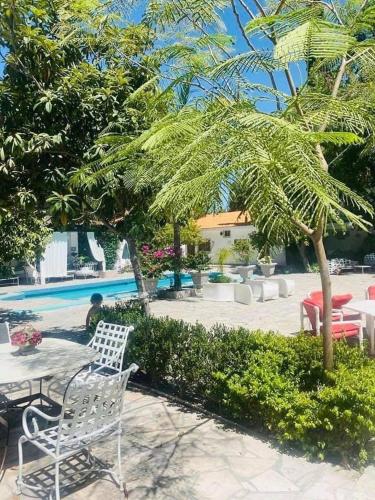 a patio with a table and chairs next to a pool at La Casita Inn Bustamante in Bustamante