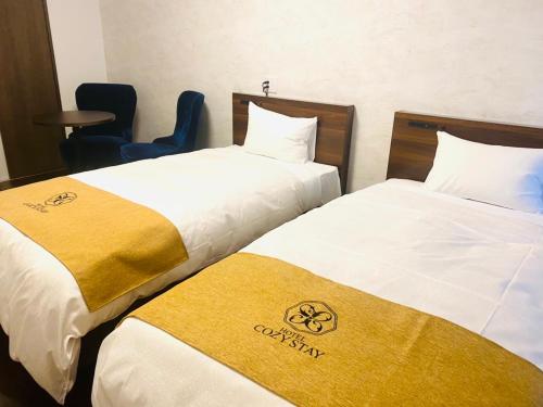 Postel nebo postele na pokoji v ubytování HOTEL Y'RISE TO URASOE