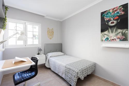 a bedroom with a bed and a painting on the wall at Casa Melo Melo by the Beach in Arona