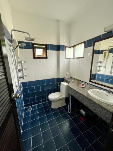 a blue tiled bathroom with a toilet and a sink at Marilyn’s Resort Koh Samui in Lamai