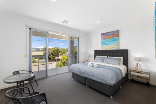 a bedroom with a large bed and a window at Western Breeze in Port Willunga