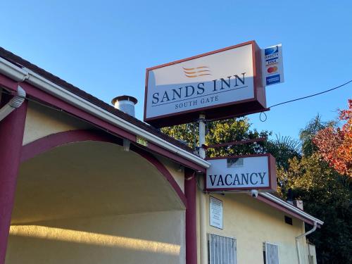 a sign for a santos inn with a sign for a sign at Sands Inn in South Gate