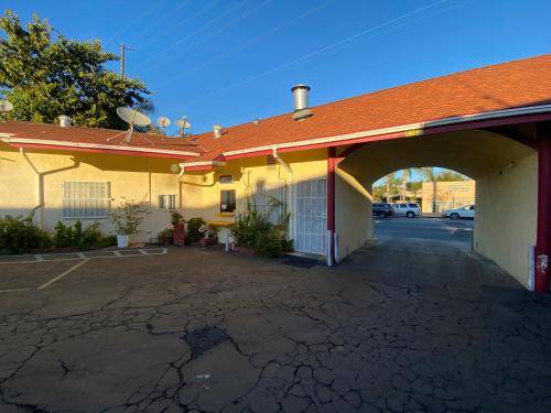 an empty parking lot in front of a building at Sands Inn in South Gate