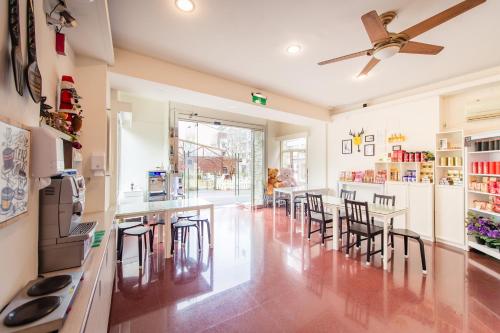 a kitchen with tables and chairs and a ceiling fan at Moonlake B&B in Yuchi