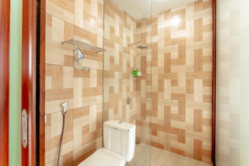a bathroom with a toilet and a shower at Bhuana Agung Villa and Restaurant in Jatiluwih