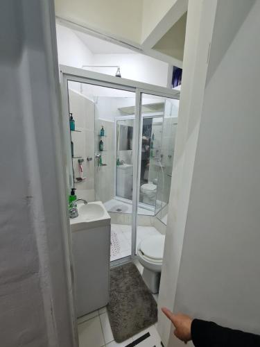 a white bathroom with a toilet and a sink at Casa Itzae B&B Polanquito Dog Friendly in Mexico City