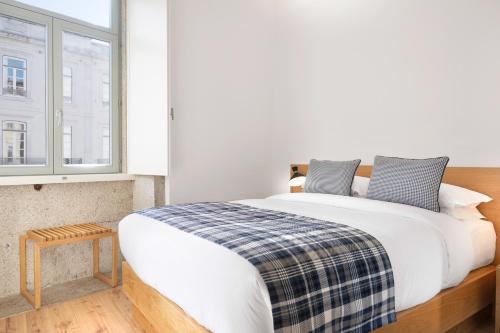 a bedroom with a large bed and a window at Mouzinho da Silveira Unique Apartments, by Oporto Collection in Porto