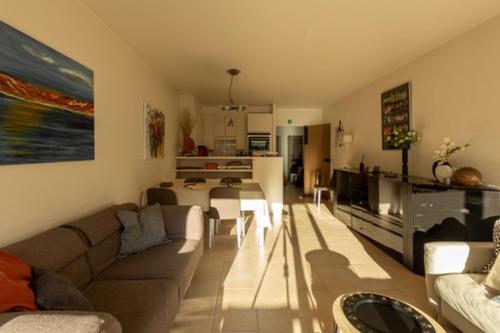 a living room with a couch and a table at Apartment Casino in Nieuwpoort