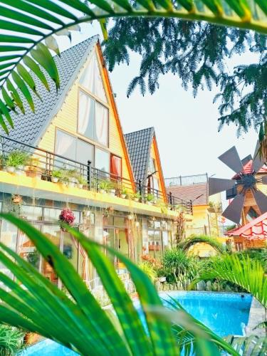 a house with a pool in front of it at Sa Mộc House Tam Đảo - Venuestay in Vĩnh Phúc