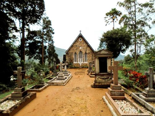 an old church with graves in front of it at Traveller's Villa in Hatton