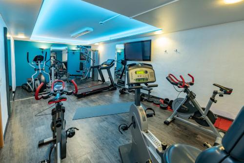 a gym with several treadmills and exercise bikes at Göbel's Seehotel Diemelsee in Diemelsee
