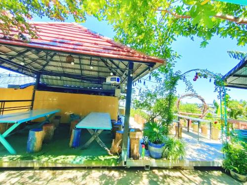 a pavilion with a picnic table in a park at Sa Mộc House Tam Đảo - Venuestay in Vĩnh Phúc