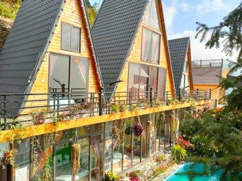 a house with a lot of windows and a swimming pool at Sa Mộc House Tam Đảo - Venuestay in Vĩnh Phúc