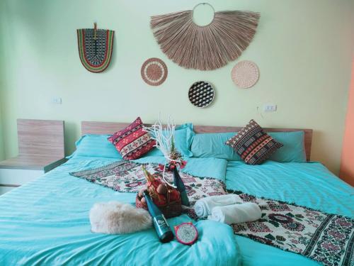 a bed with blue sheets and pillows on it at Sa Mộc House Tam Đảo - Venuestay in Vĩnh Phúc