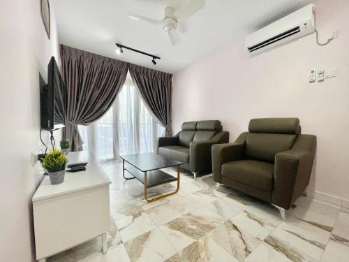 a living room with two chairs and a table at Century Suria Aparment Langkawi by Zervin in Kuah
