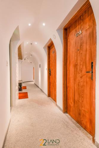 a hallway with a large wooden door in a house at 22Land Hotel & Residence in Hanoi