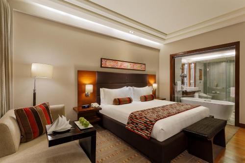 a hotel room with a bed and a bath tub at Crowne Plaza Today Gurugram by IHG in Gurgaon