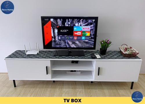 a tv on a white entertainment center with a tv box at Revo Home at Pavilion Bukit Jalil in Kuala Lumpur
