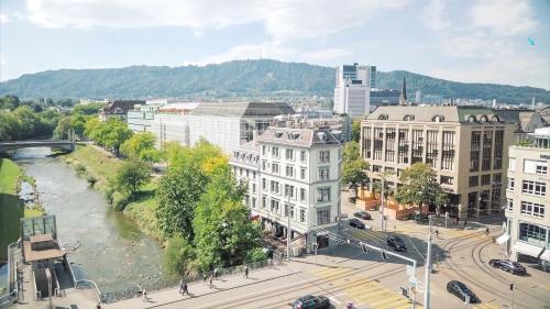 a view of a city with a river and buildings at Boutique Hotel Helvetia in Zurich