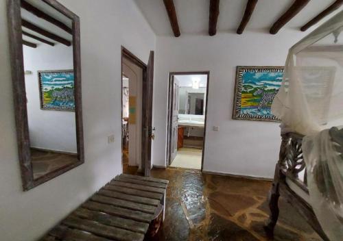 a hallway of a house with a mirror and a staircase at Marine Holiday House in Malindi