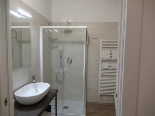 a white bathroom with a sink and a shower at Maso Agritur Santa Lucia in Dro