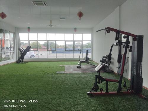 a gym with a green carpeted room with tread machines at PavilionVillie Ipoh in Kampong Sengat
