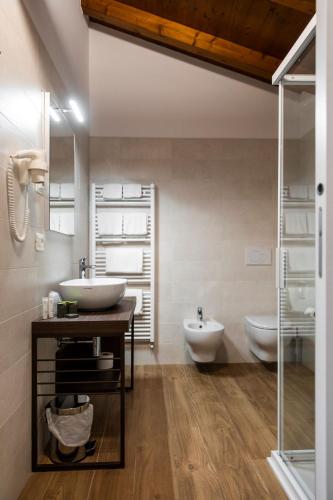 a bathroom with two sinks and two toilets at Maso Agritur Santa Lucia in Dro