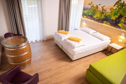 a bedroom with a bed and a wine barrel at Maso Agritur Santa Lucia in Dro
