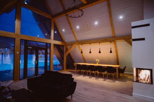 a dining room of a house with a table and chairs at Treeline Cabins in Cădăreşti