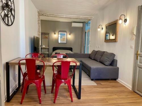 - un salon avec une table, des chaises et un canapé dans l'établissement République - Dauder de Selva, à Perpignan