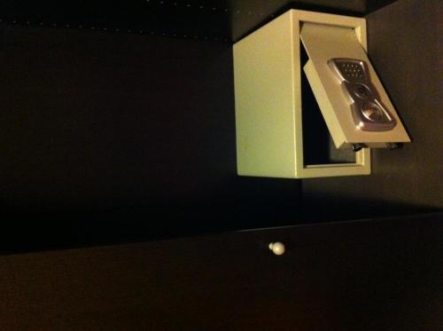 a microwave hanging on a wall in a bathroom at Hotel Mosaic in Rome